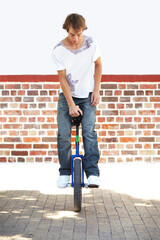 Hes got skill. Full-length shot of a young man balancing on a unicycle. © Alexander S/peopleimages.com
