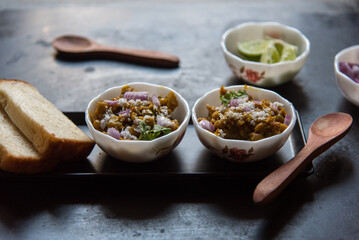 Popular Indian street food ghugni or yellow peas masala served in bowl. Close up, selective focus.