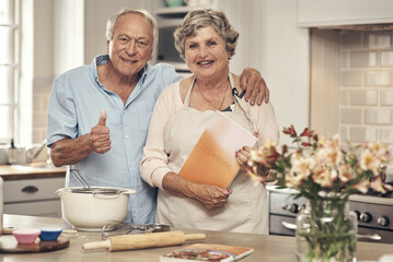 Its a good day to bake a cake. Shot of a senior couple baking together at home.