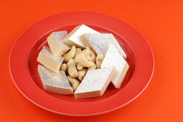 Kaju Katli is a traditional Indian Diamond shaped sweet or Mithai made using cashew paste, sugar, and mava or Khoya.cashew barfi