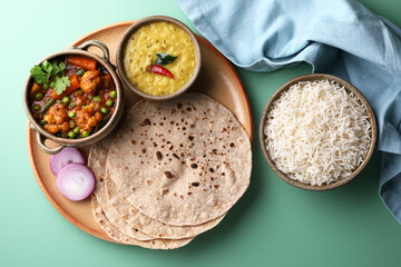 vegetarian Indian thali or Indian home food with lentil dal, cauliflower curry, roti or Indian flat bread and rice