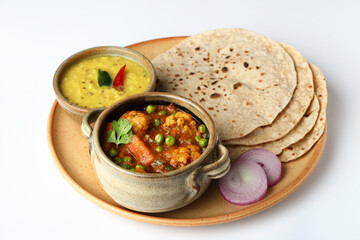vegetarian Indian thali or Indian home food with lentil dal, cauliflower curry, roti or Indian flat bread  