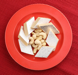 Kaju Katli is a traditional Indian Diamond shaped sweet or Mithai made using cashew paste, sugar, and mava or Khoya.cashew barfi