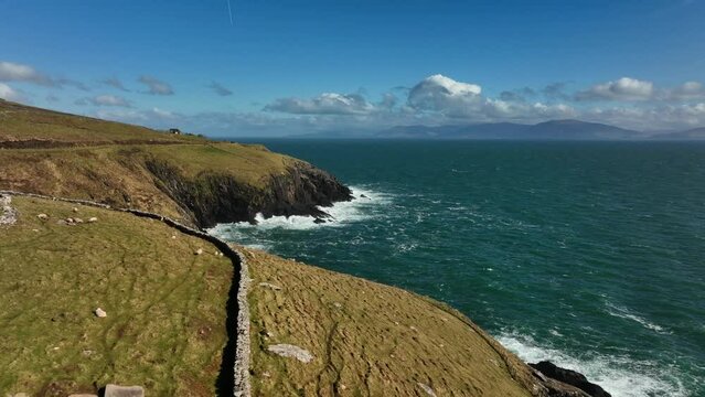 Ventry, Kerry, Ireland, March 2022. Drone pushes east along the Dingle Way following the craggy coastline along the Wild Atlantic Way with Ballymacdoyle and Dooties in the distance.