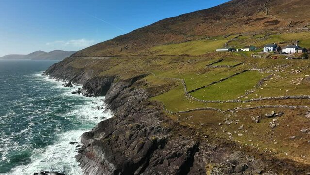 Ventry, Kerry, Ireland, March 2022. Drone tracks west along the Dingle Way following the craggy coastline gradually revealing the Blasket Islands and North Atlantic Ocean in the distance.