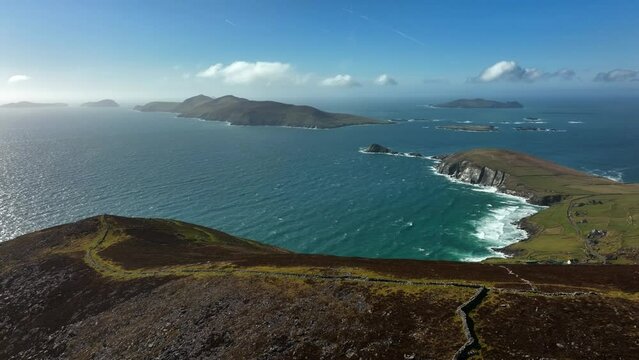 Coumeenoole Bay, Kerry, Ireland, March 2022. Drone pulls east from Ventry facing northwest towards Dunmore with the cliffs, Blasket Islands and North Atlantic Ocean in the distance.