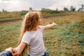 Little girl holding hand and showing the road.