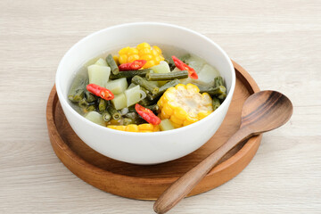 Sayur asam, sayur asem or tamarind soup is a popular traditional Indonesian soup. Common ingredients are chayote, long beans and corn with the addition of tamarind or bilimbi. Served in white bowl.
