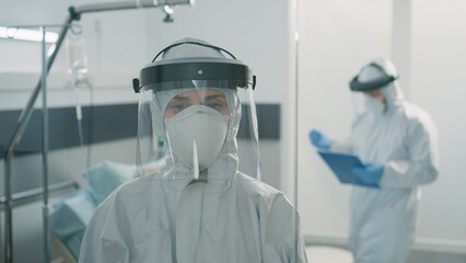 Portrait of woman with protective suit against coronavirus outbreak in lockdown zone. Close up of...