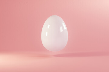 Easter white egg flying on pink background. Minimal easter concept. Happy Easter card with copy space for text. Levitating egg.