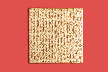 Matzah for Jewish holiday Pesach on red background.
