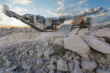 Heavy and mobile machinery in a quarry to transform stone into construction material