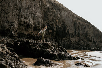 woman walking on rocks at the beach