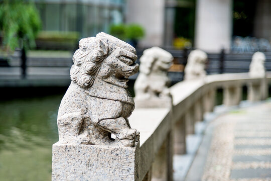 Row of stone lion statues on the edge of China pond