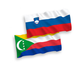 National vector fabric wave flags of Slovenia and Union of the Comoros isolated on white background. 1 to 2 proportion.