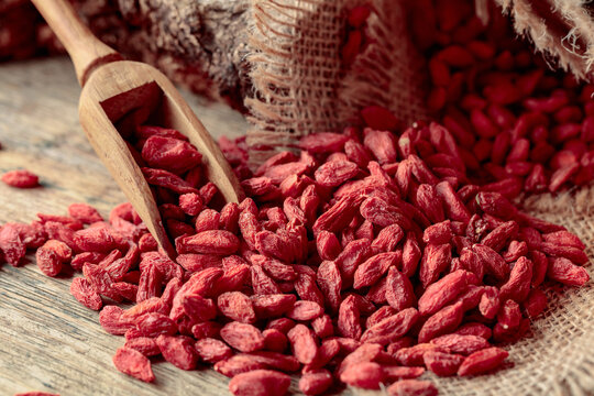 Dried goji berries on a wooden table.