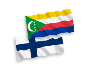 National vector fabric wave flags of Finland and Union of the Comoros isolated on white background. 1 to 2 proportion.