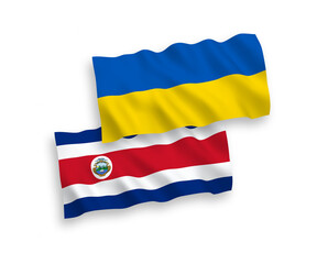 National vector fabric wave flags of Republic of Costa Rica and Ukraine isolated on white background. 1 to 2 proportion.