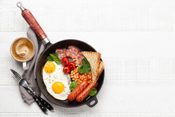 English breakfast with fried eggs, beans, bacon and sausages