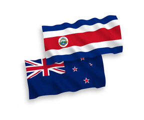 National vector fabric wave flags of Republic of Costa Rica and New Zealand isolated on white background. 1 to 2 proportion.