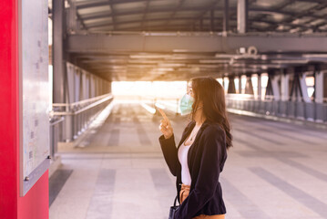 Women checking time schedule at train station,Travel insurance concept