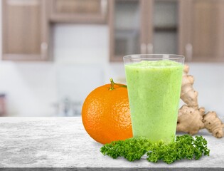 Detox juice, glass with green juice on a board, small fruit ingredient for the juice