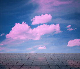 pink clouds, blue sky, gray floor.