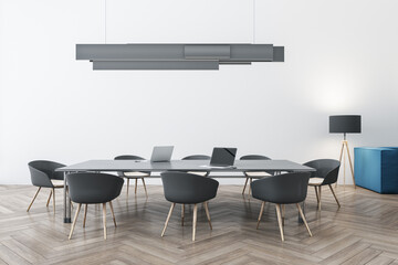 Fototapeta na wymiar Luxury concrete and wooden meeting room interior with furniture, ceiling lamp and laptop device on table. Workplace and conference concept. 3D Rendering.
