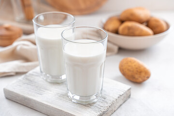 Vegetarian potato milk in two glasses on a light background.