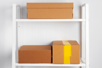 Stack of cardboard package boxes on wooden rack