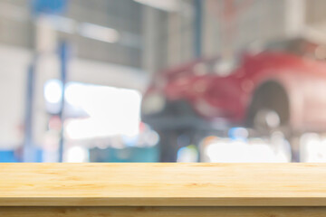 Empty wood table top with car service centre auto repair workshop blurred background