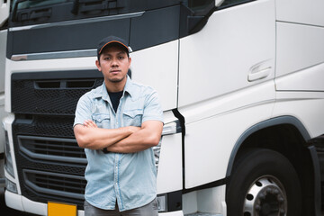 Asian Truck Driver Standing Cross One's Arm with Semi Trailer Trucks. Cargo Shipping Freight Truck...