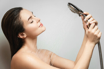 Beautiful sensual woman washing under shower spray