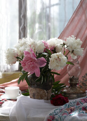 Still life with white and pink peonies in a old ceramic vase - 495592508