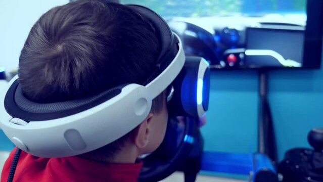 the boy in virtual reality glasses is playing.
