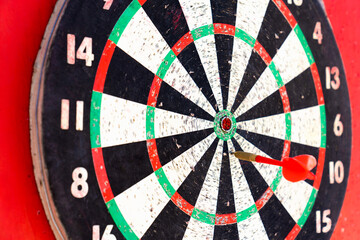 The target of the game of darts on a red background. Concept of success and goal achievement