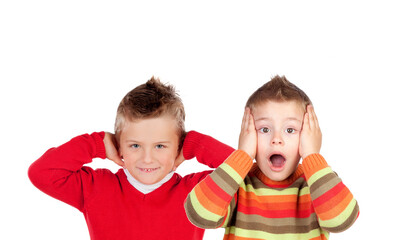 Children covering the ears and shocked by a loud sound