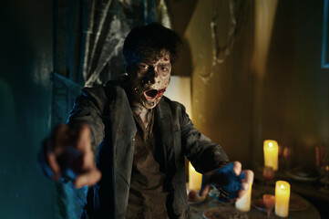 Fototapeta na wymiar Portrait of scary bloodthirsty zombie man attack