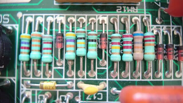 Close up view of different frequency resistors on motherboard.