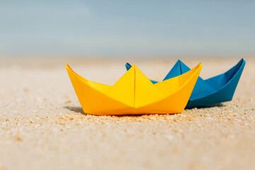 Fototapeta na wymiar colorful paper boats at the tropical beach