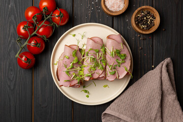 Toast on fresh toasted bread with cream cheese, ham and microgreens, flat lay, open space