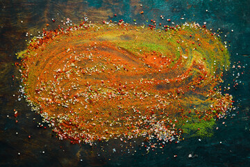 Set of spices and seasonings on a black stone background. Top view.