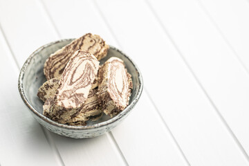 Sweet tahini halva with cocoa flavor. Turkish dessert in bowl.