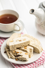 Sweet tahini halva with almonds. Turkish dessert on plate.