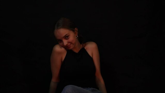 Shy pretty teenage girl flirting by giving a wink