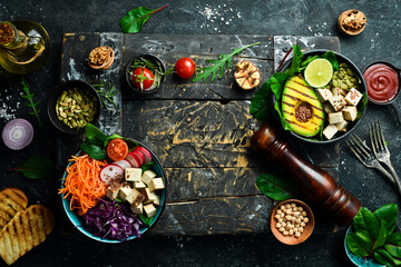 Healthy vegetarian eating, super food. The concept of healthy eating. On a black stone background. Top view.
