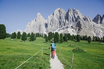 Fototapeta na wymiar Hiker man on the most popular Dolomites trail. Famous best alpine place of the world, Odle mountain peaks, South Tyrol, Northern Italy