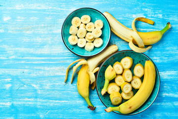 Tropical bananas on a blue wooden background. Top view.