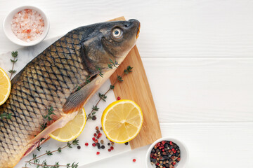 Raw fish carp for preparation for the holiday Christmas on a background. Czech Traditional Christmas Food. Top view