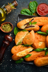 Homemade pies with peas, potatoes and liver. Top view. Free copy space.